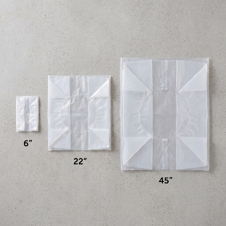 Three folded round drum liners laid flat and labelled 6 inch, 22 inch and 45 inch diameter